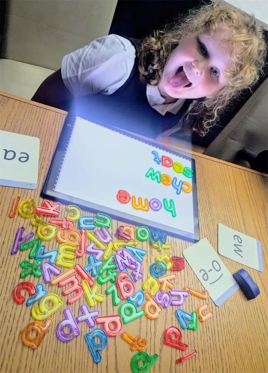 A pupil enjoying a creative painting activity