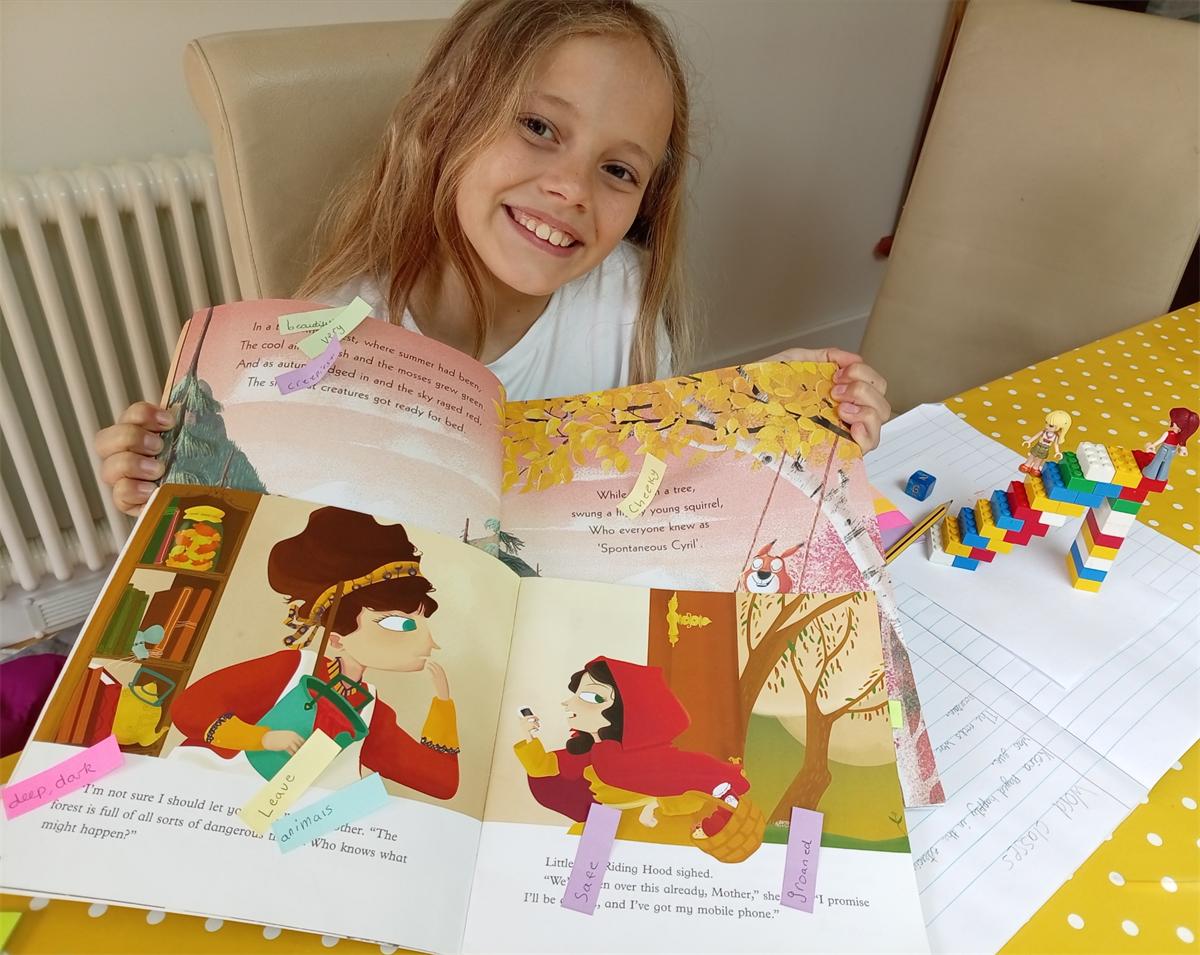 A pupil reading with colourful learning resources