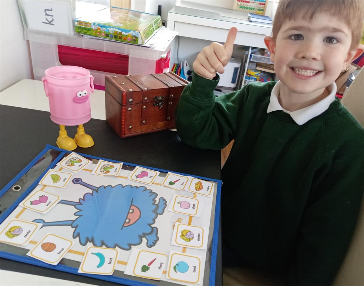 A pupil playing a matching game at the learning table