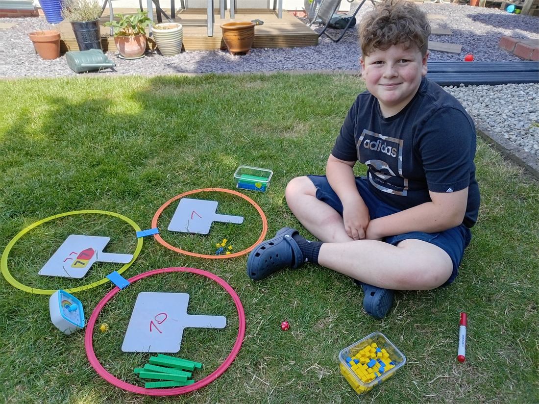 An outdoor home education maths activity with hoops